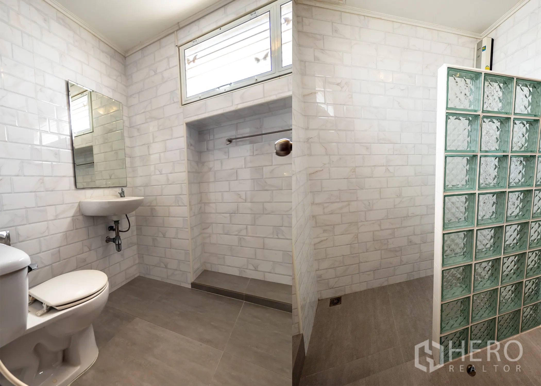 Townhouse for rent in Khlong Toei, Bangkok - Bathroom with marble-look subway tiles and glass-block partition in the shower.
