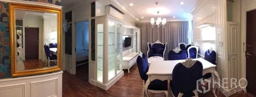 Condominium for rent in Watthana, Bangkok - Open-plan living and dining area with glass display unit and chandelier.