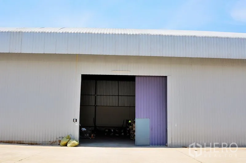 Warehouse for rent in Lat Krabang, Bangkok - Front of metal warehouse with large sliding door and concrete loading apron in Lat Krabang