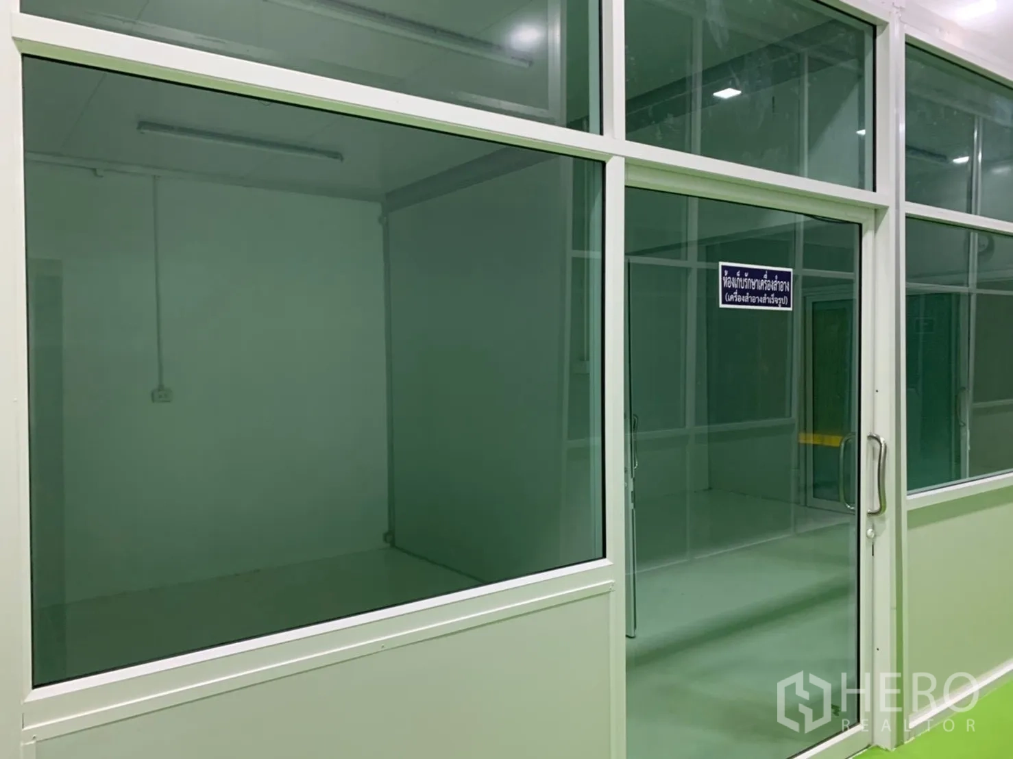 Factory for rent in Khlong Luang, Pathum Thani - Enclosed workspace with large glass panels and a sliding door.
