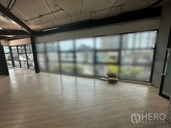 Office Space for rent in Chatuchak, Bangkok - Loft-style open office with floor-to-ceiling windows and wood flooring overlooking the city.