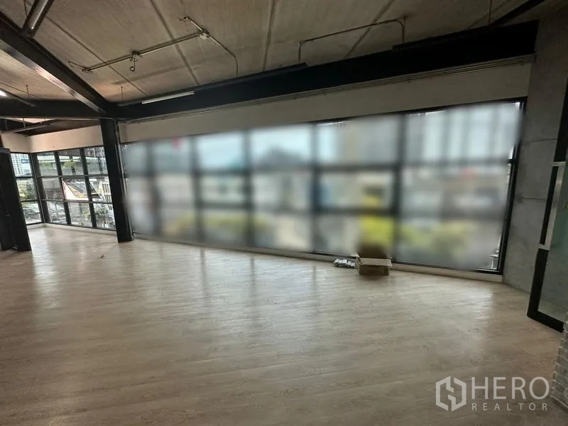 Office Space for rent in Chatuchak, Bangkok - Loft-style open office with floor-to-ceiling windows and wood flooring overlooking the city.