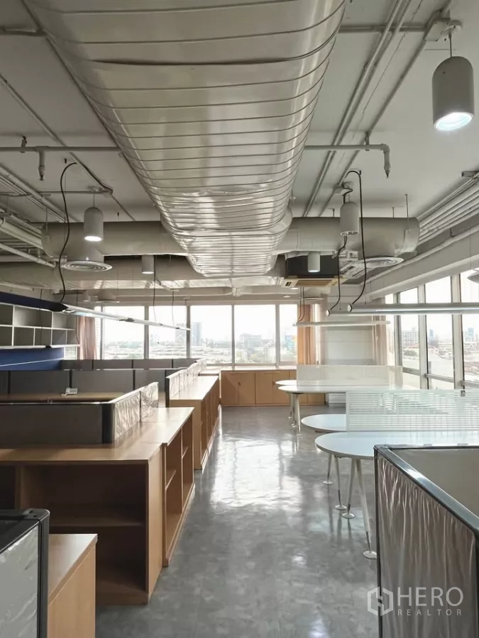Office Space for rent in Khlong Toei, Bangkok - Bright open-plan office with suspended linear lights, ducted air-conditioning and a wall of windows.