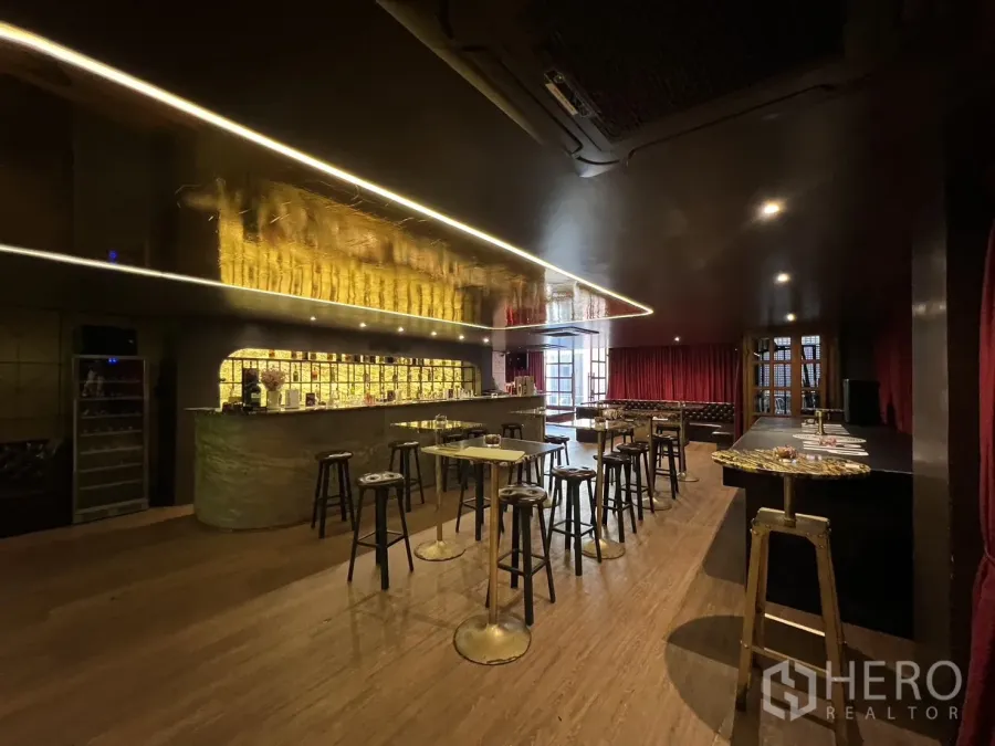 Retail Space for rent in Watthana, Bangkok - Dimly lit lounge with backlit stone bar, high tables and wood flooring.