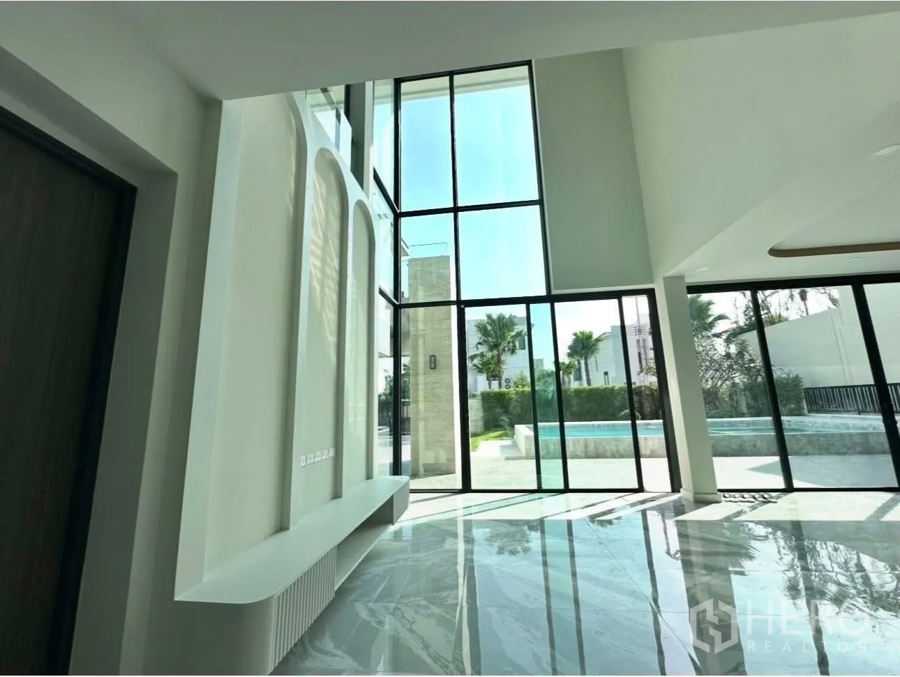 Detached House for sale in Bang Khen, Bangkok - Living space opening to the pool terrace through large sliding glass doors.