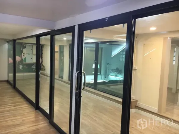 Retail Space for rent in Watthana, Bangkok - Black-framed sliding glass doors separating flexible retail areas.