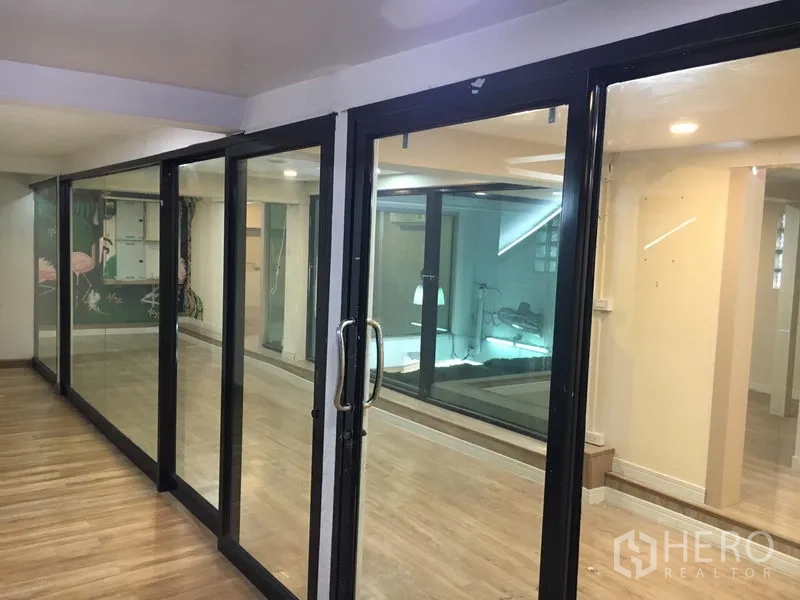 Retail Space for rent in Watthana, Bangkok - Black-framed sliding glass doors separating flexible retail areas.