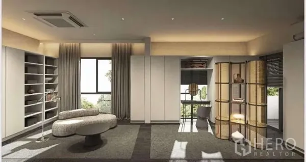 Townhouse for rent in Suan Luang, Bangkok - Open lounge with shelving walls, curved sofa, and floor-to-ceiling windows overlooking greenery.