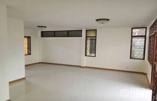 Office Space for rent in Chatuchak, Bangkok - Large flexible room with tiled floors, window grilles and ceiling lights for workstations.