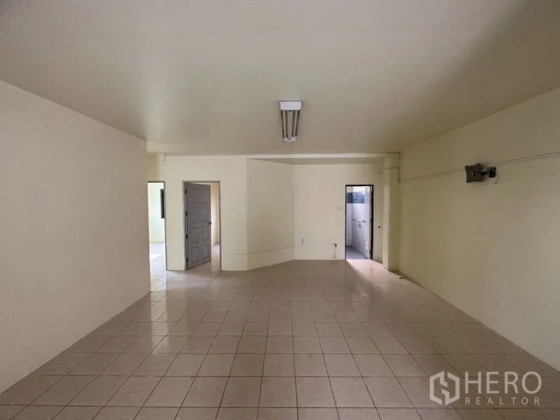 Factory for rent in Bang Bua Thong, Nonthaburi - Tiled office room with doorway and restroom access.