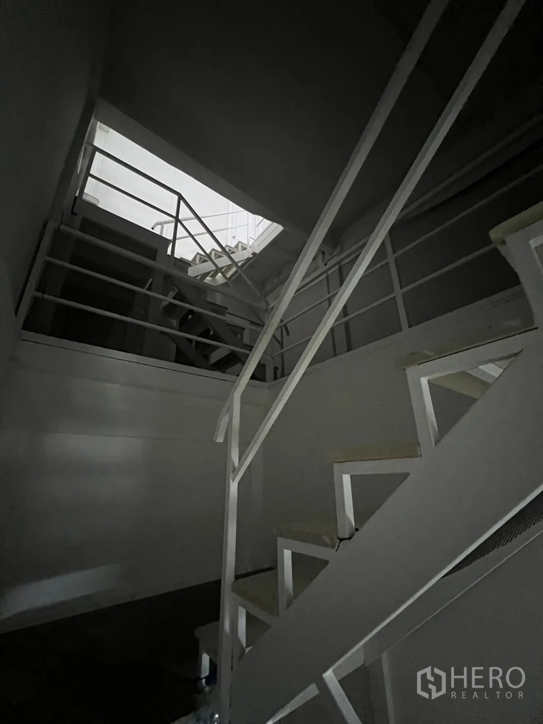 Shophouse for rent or sale in Khlong Toei, Bangkok - Interior stairwell with natural light from roof opening.
