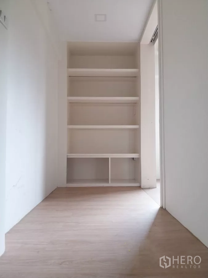 Retail Space for rent - Built-in storage shelves in a small corridor within the retail space.