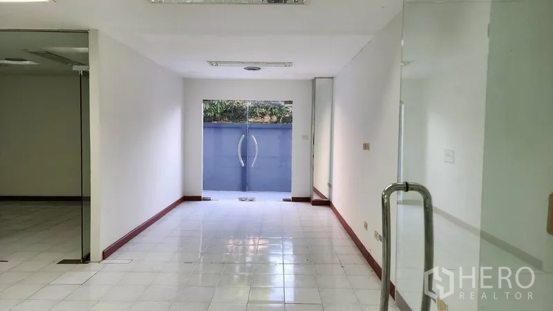Office Space for rent or sale in Khlong Toei, Bangkok - Ground-floor corridor leading to glass double doors and the front courtyard.