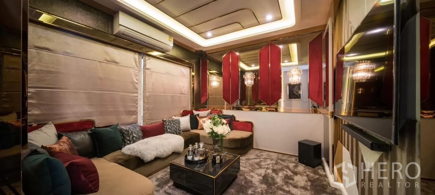 Detached House for rent in Prawet, Bangkok - Cozy media room with sectional sofa, accent lighting and a wall-mounted TV