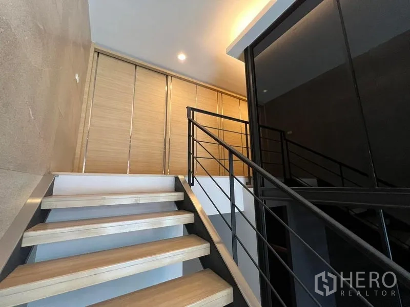 Home Office for rent in Bueng Kum, Bangkok - Stairway to upper floor beside dark glass meeting box.