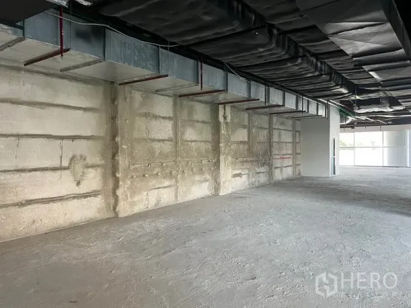 Retail Space for rent in Bang Rak, Bangkok - Large retail interior showing concrete wall, insulated ceiling and ducting ready for fit-out.