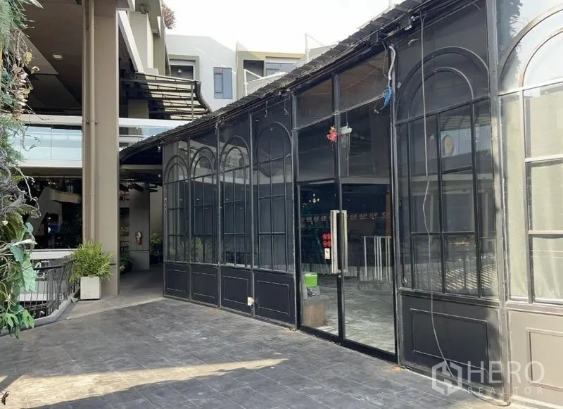 零售空间 出租 - 主入口为高挑玻璃门与拱窗，毗邻商场中庭。