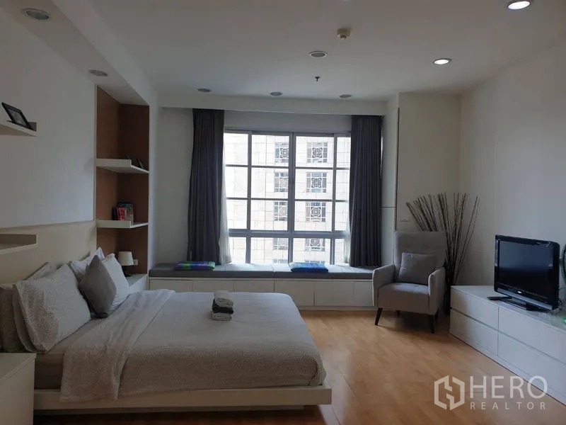 Condominium for rent in Khlong Toei, Bangkok - Compact separate kitchen with stainless refrigerator, oven, and mosaic backsplash.