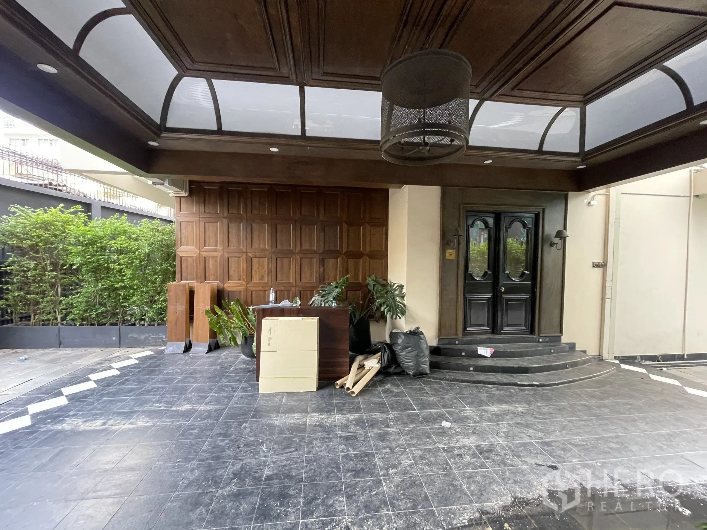 Detached House for rent - Front entry with paneled wood wall and skylight canopy over a tiled forecourt.