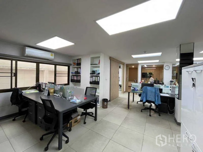 Home Office for rent in Watthana, Bangkok - Bright workspace with shared desks, storage shelves and LED panels.