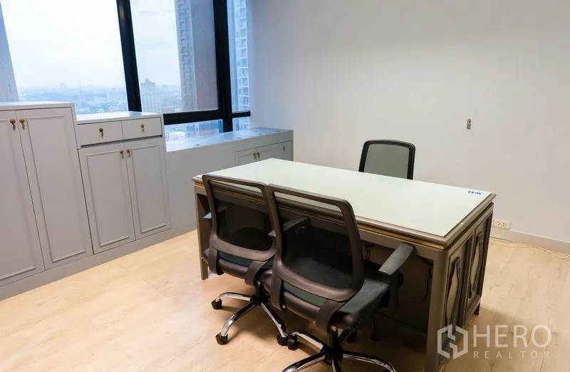 Office Space for rent - Manager’s office with built-in storage, large desk and skyline views.