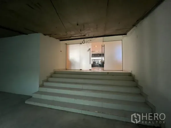 Office Space for rent - Short staircase to glass doors at the entrance of the office space.