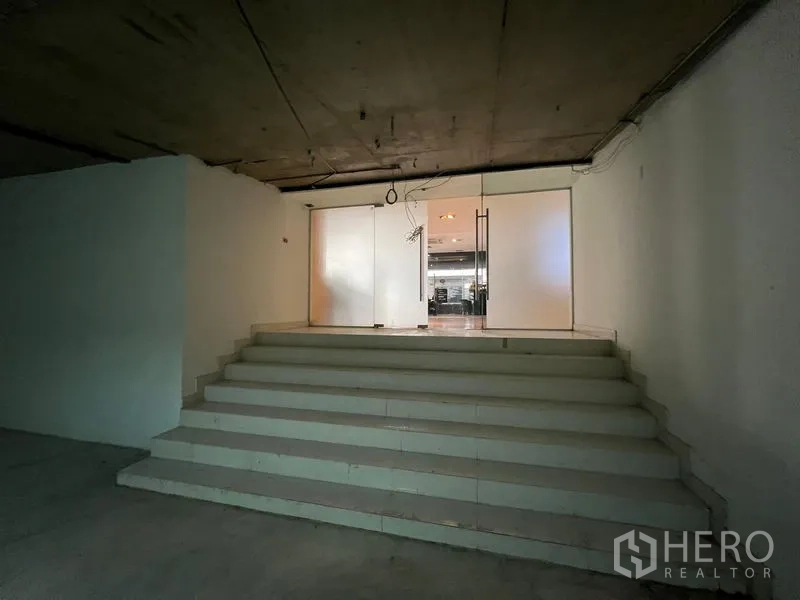 Office Space for rent - Short staircase to glass doors at the entrance of the office space.
