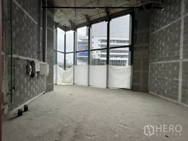 Retail Space for rent - Open 46 sqm retail unit showing floor‑to‑ceiling glazing and block walls ready for tenant fit‑out.