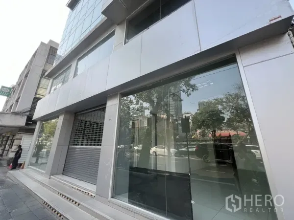 Retail Space for rent in Bang Rak, Bangkok - Street-facing glass storefront with wide display windows and a security roller shutter.