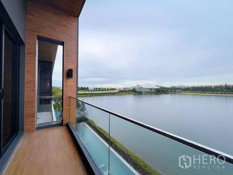 Detached House for sale in Bang Phli, Samut Prakan - Upper-floor balcony with glass railing overlooking a wide water view.