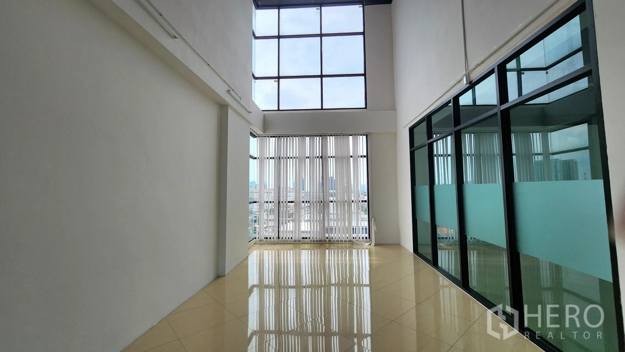 Office Space for rent in Yan Nawa, Bangkok - Hallway between glass offices with exposed ceiling pipes and lighting.