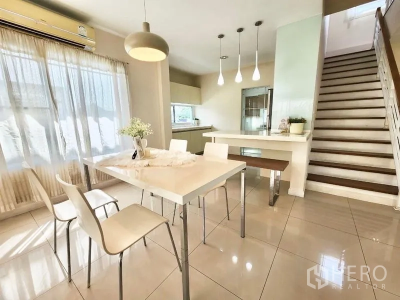 Detached House for rent in Prawet, Bangkok - Open dining and pantry space with pendant lighting next to the staircase.