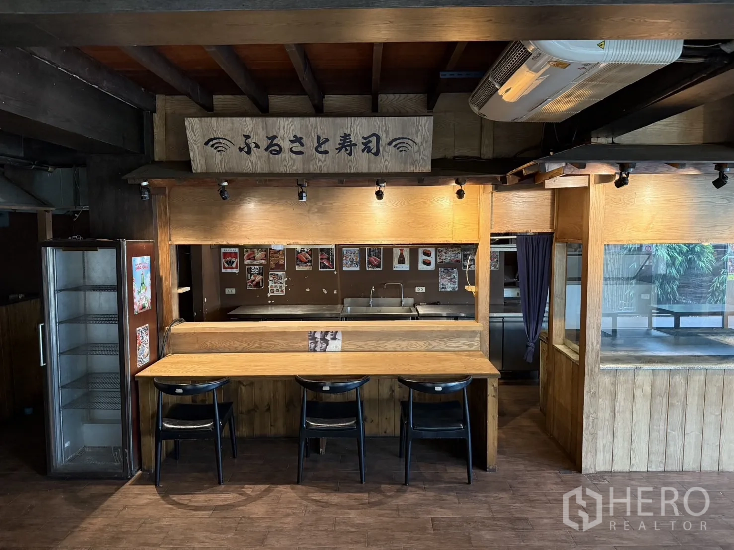 Detached House for rent in Watthana, Bangkok - Wooden bar counter with stools and display area inside the house.