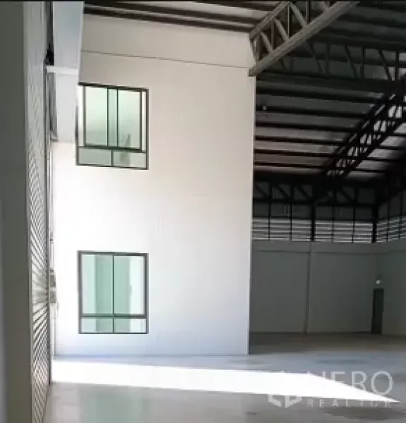 工厂 出售在Bang Bo, Samut Prakan - 仓库内部，12米层高，钢桁架结构，旁侧为办公区窗户。