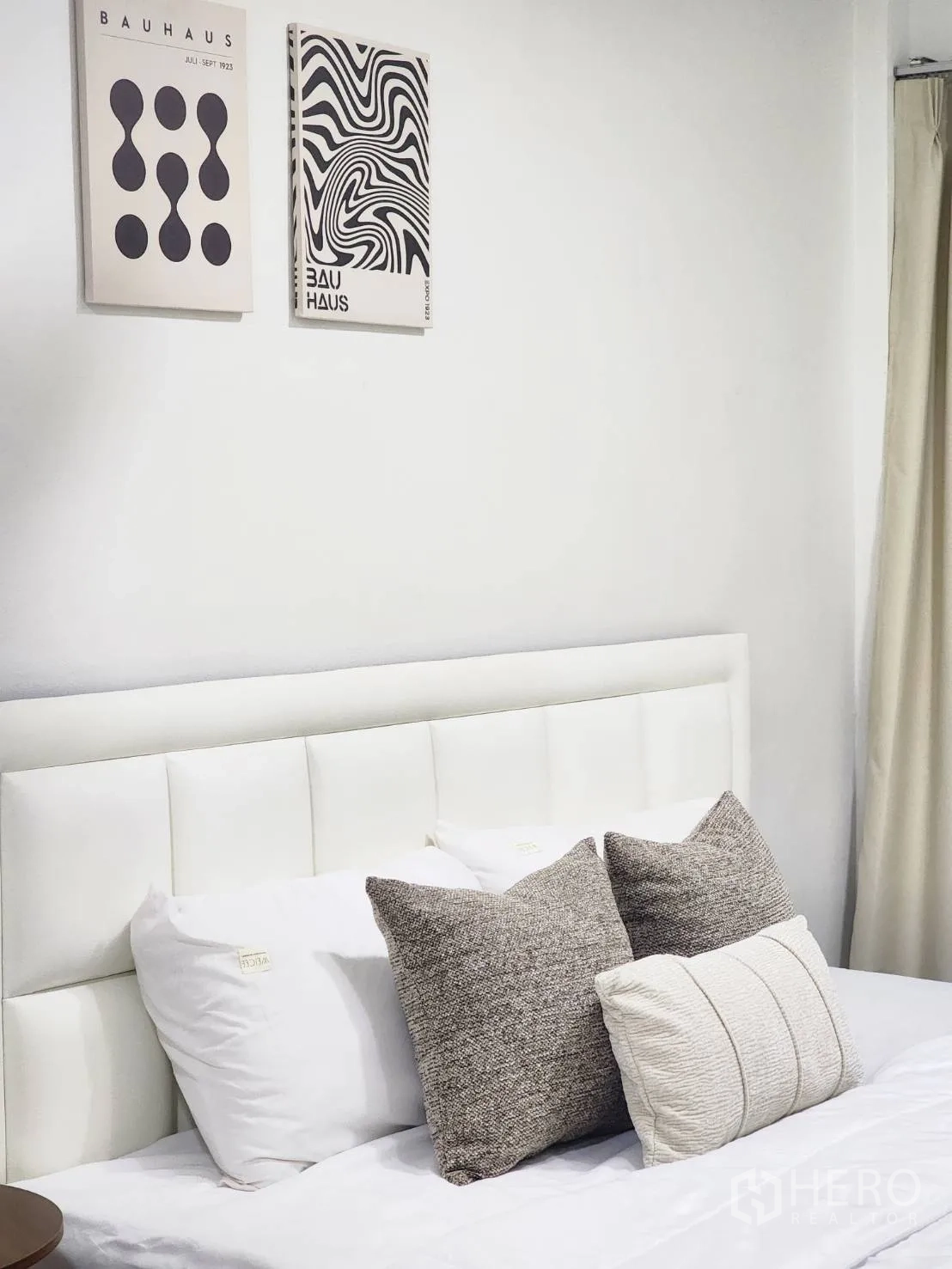 Detached House for rent in Huai Khwang, Bangkok - Close-up of padded headboard with neutral pillows and modern wall art.