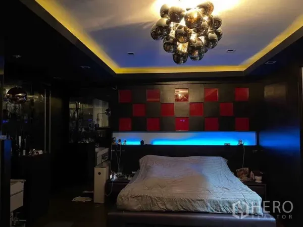Detached House for sale in Suan Luang, Bangkok - Moody bedroom with modern chandelier, accent lighting and red-and-black headboard wall.
