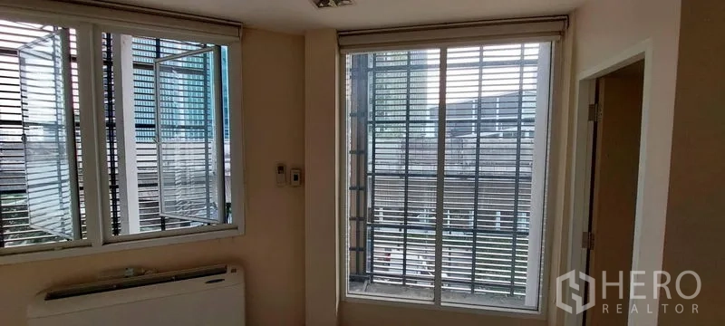 Retail Space for rent - Corner area with large sliding windows and exterior louvered screens.