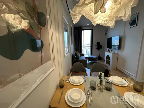 Condominium for sale - Dining area set for four leading to the living room and balcony with city view.