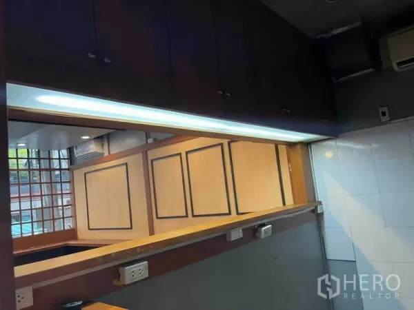 Retail Space for rent in Watthana, Bangkok - Service counter with pass-through window, overhead light strip, upper cabinets and a tiled prep area.
