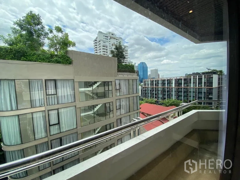 Condominium for rent in Khlong Toei, Bangkok - Balcony with city view over neighboring residences and skyline.