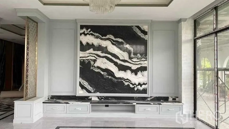Detached House for sale in Mueang Nonthaburi, Nonthaburi - Close view of statement marble feature wall with low storage drawers and chandelier above.