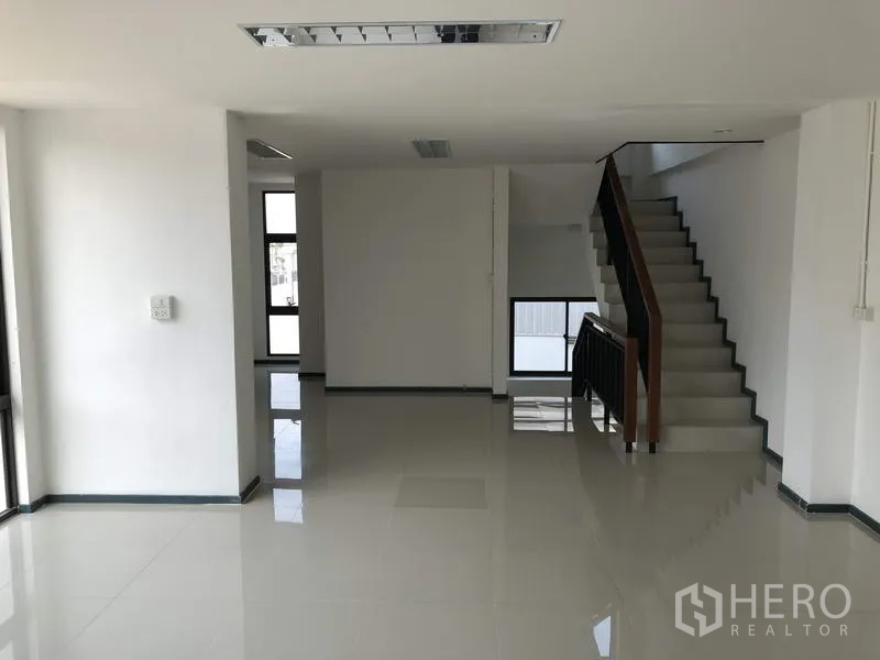 Warehouse for rent or sale in Lam Luk Ka, Pathum Thani - Ground-floor office lobby with glossy floors and a staircase leading to upper levels.