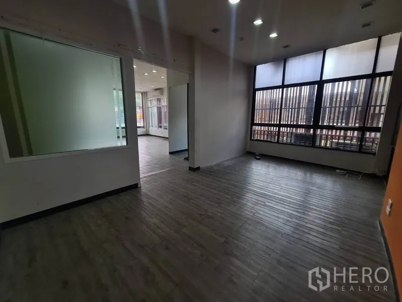 Retail Space for rent in Watthana, Bangkok - Back area with a frosted glass partition and tall barred windows.
