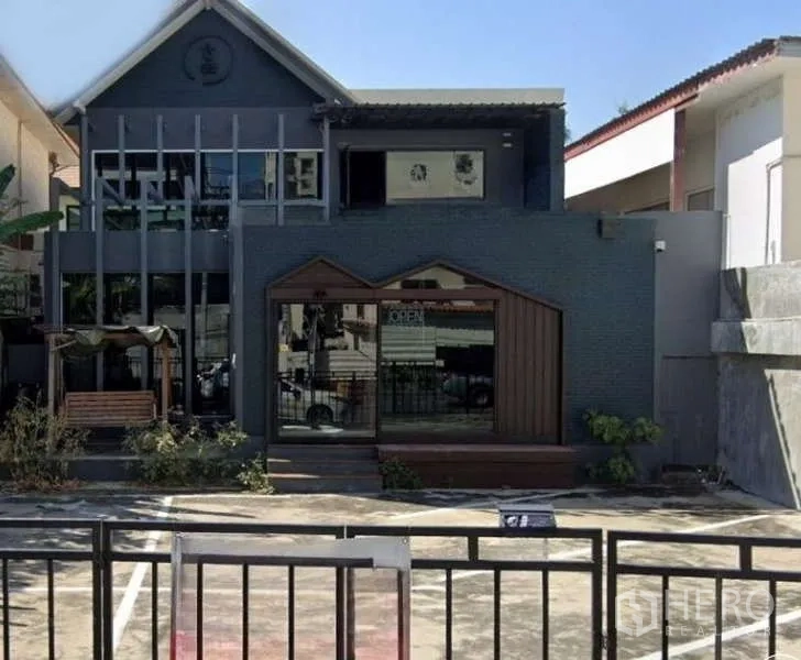 Detached House for rent in Watthana, Bangkok - Modern two-storey detached house facade with large windows and front parking area.