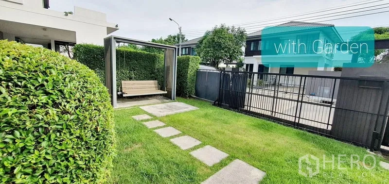 Detached House for rent in Bang Phli, Samut Prakan - Front garden with lawn, stepping stones, gate and a covered swing seat