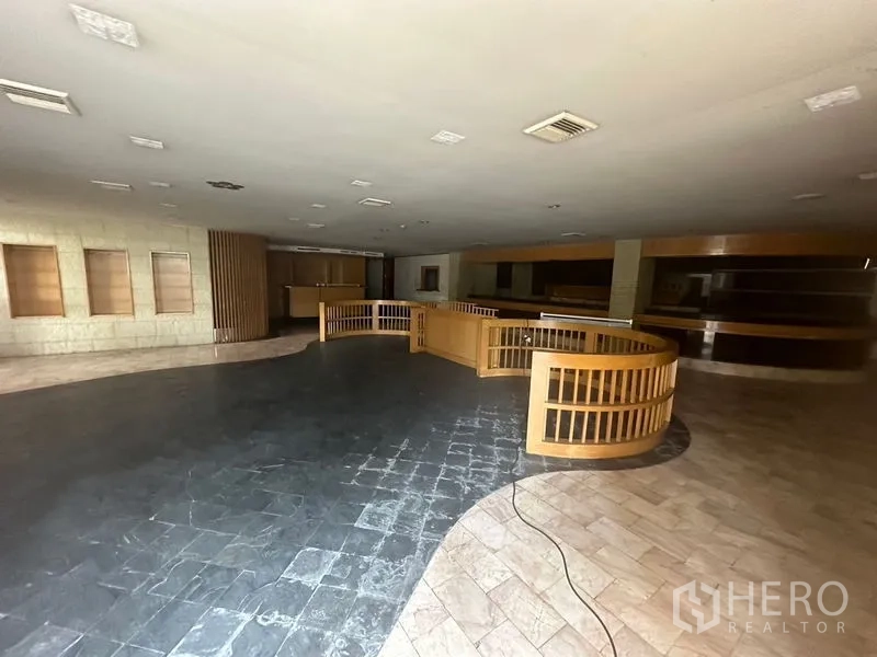 Retail Space for rent in Bang Rak, Bangkok - Dim open hall featuring a circular wooden railing and mixed flooring.
