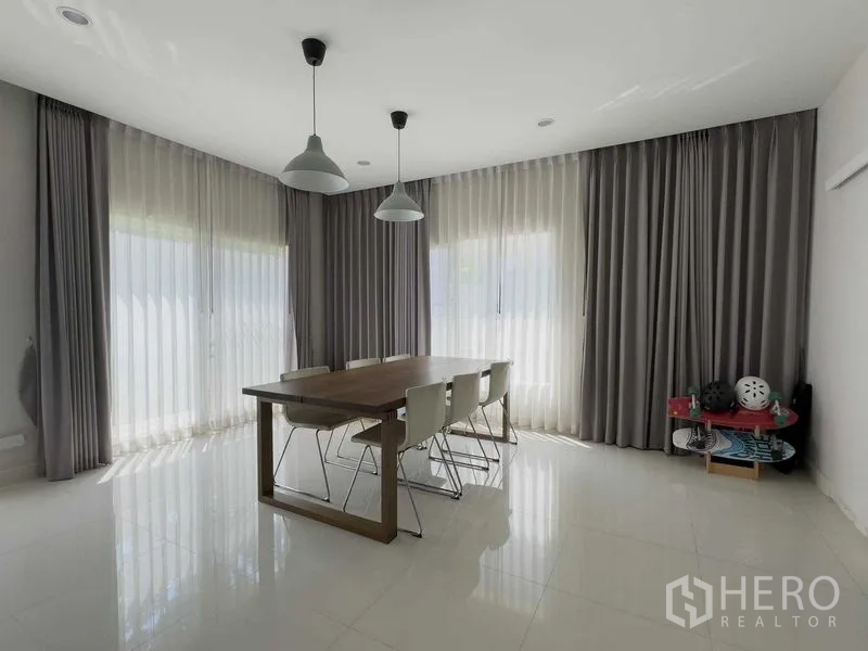 Detached House for rent or sale in Bang Khen, Bangkok - Bright dining area with full-height curtains and glossy tiled floor.