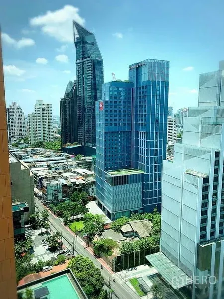 Condominium for rent in Khlong Toei, Bangkok - City skyline view over Sukhumvit with modern glass towers and a pool below.