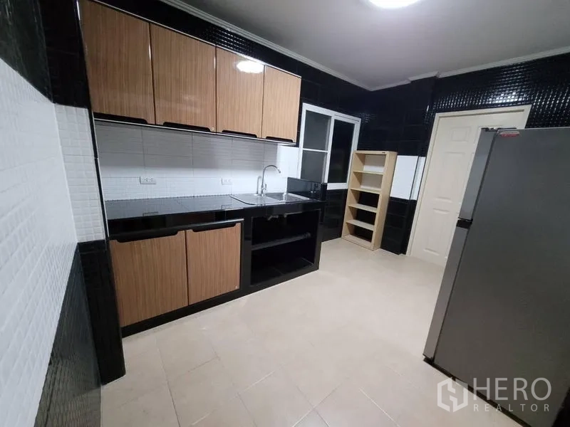 Detached House for rent - Kitchen alternate view showing ample counter space, window and fridge.