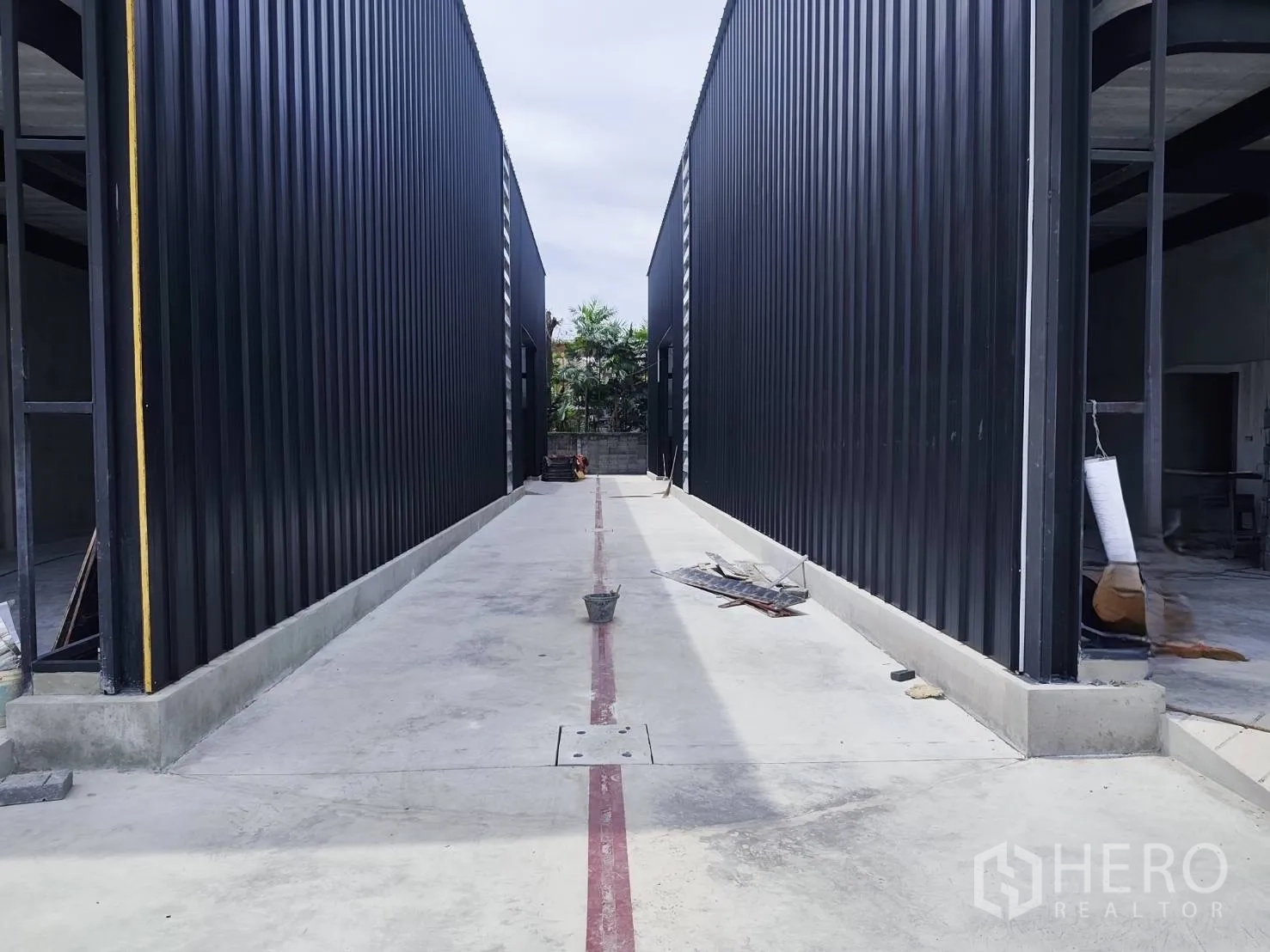 Warehouse for rent in Sai Mai, Bangkok - Central driveway between two warehouse blocks with a smooth concrete surface.